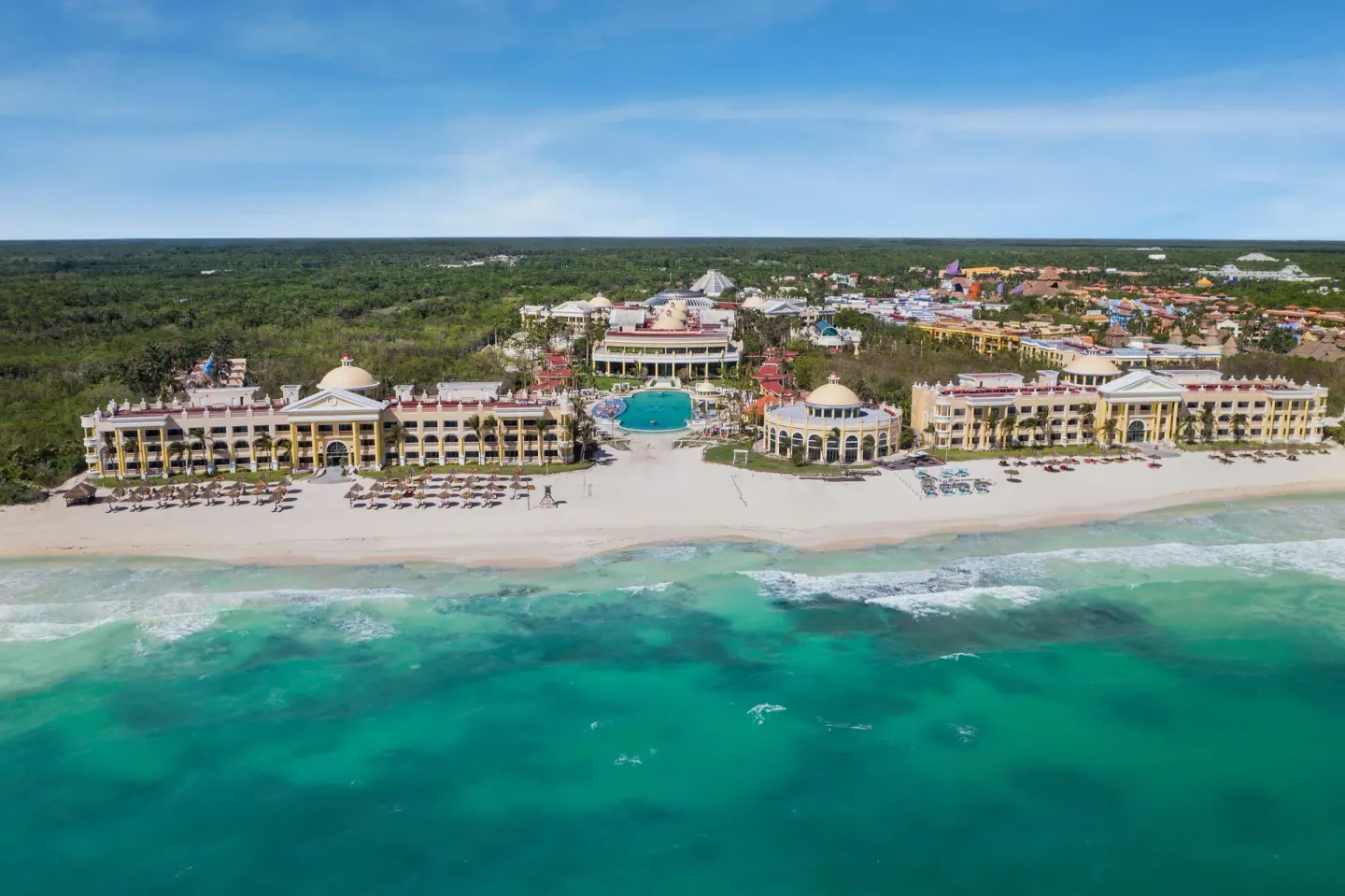 Aerial beachfront view of JOIA Paraíso by Iberostar with turquoise sea, pools, and resort buildings.
