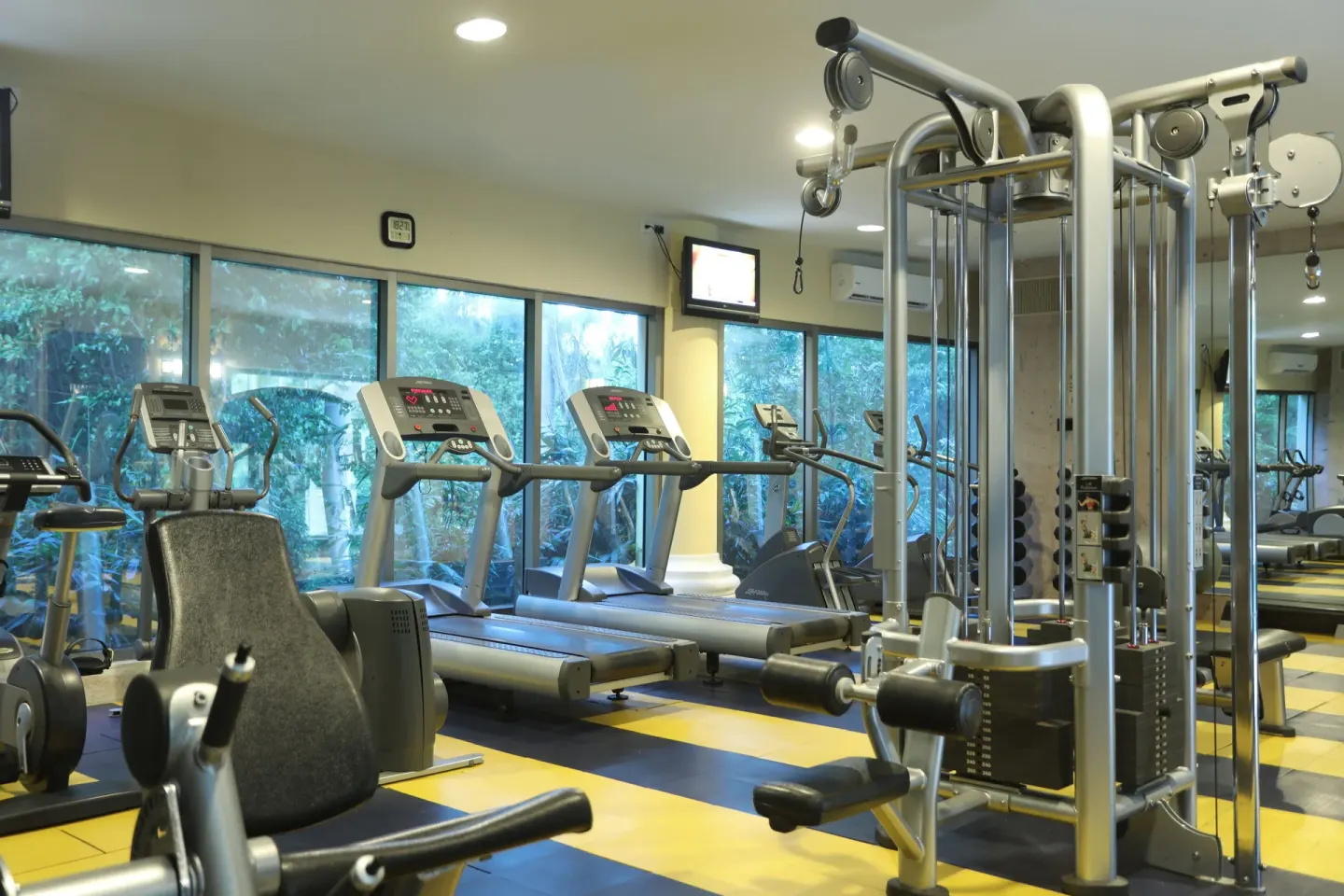 Fitness center with treadmills and weight machines at JOIA Paraíso by Iberostar.