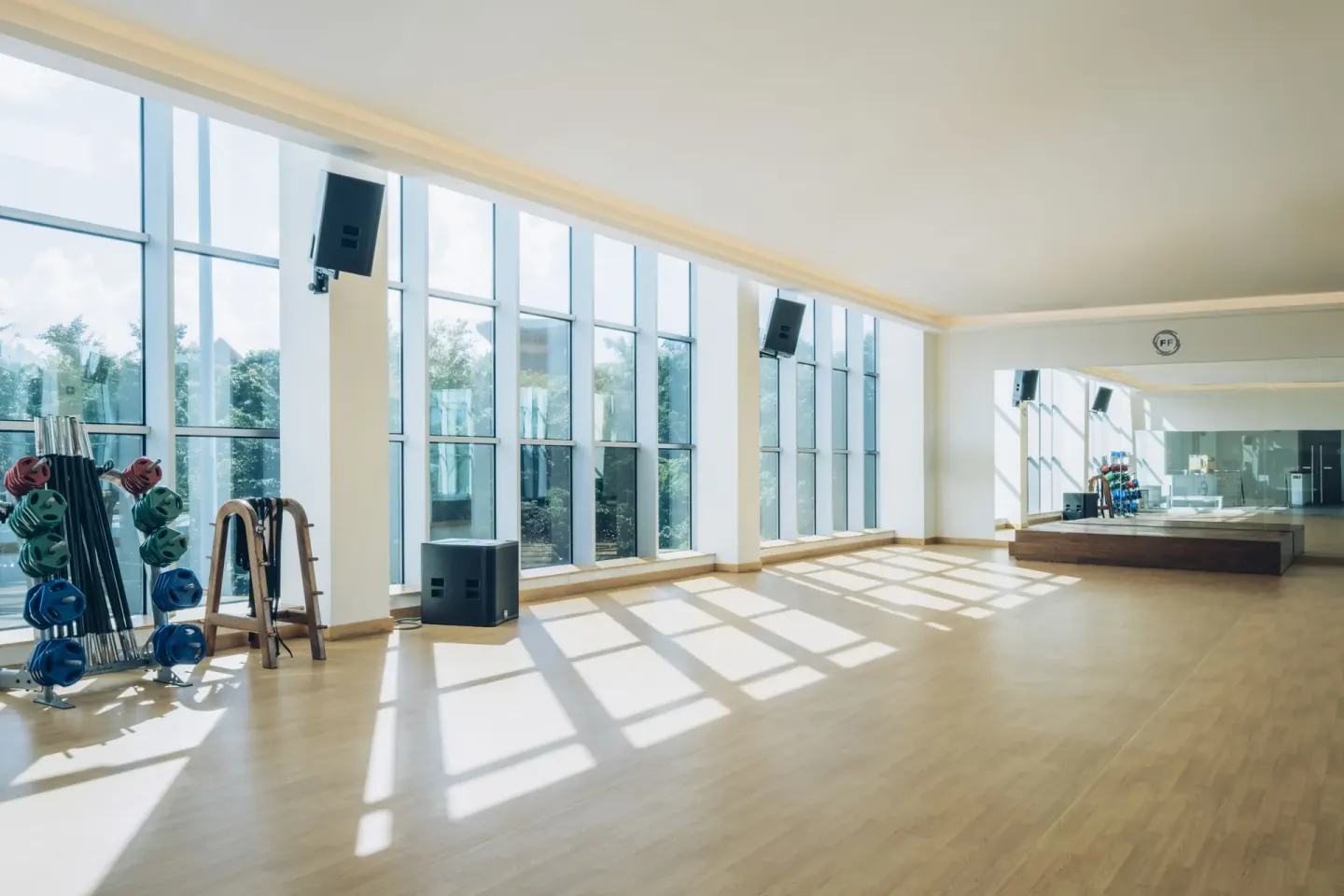 Fitness studio with mirrored wall and exercise equipment at JOIA Paraíso by Iberostar.