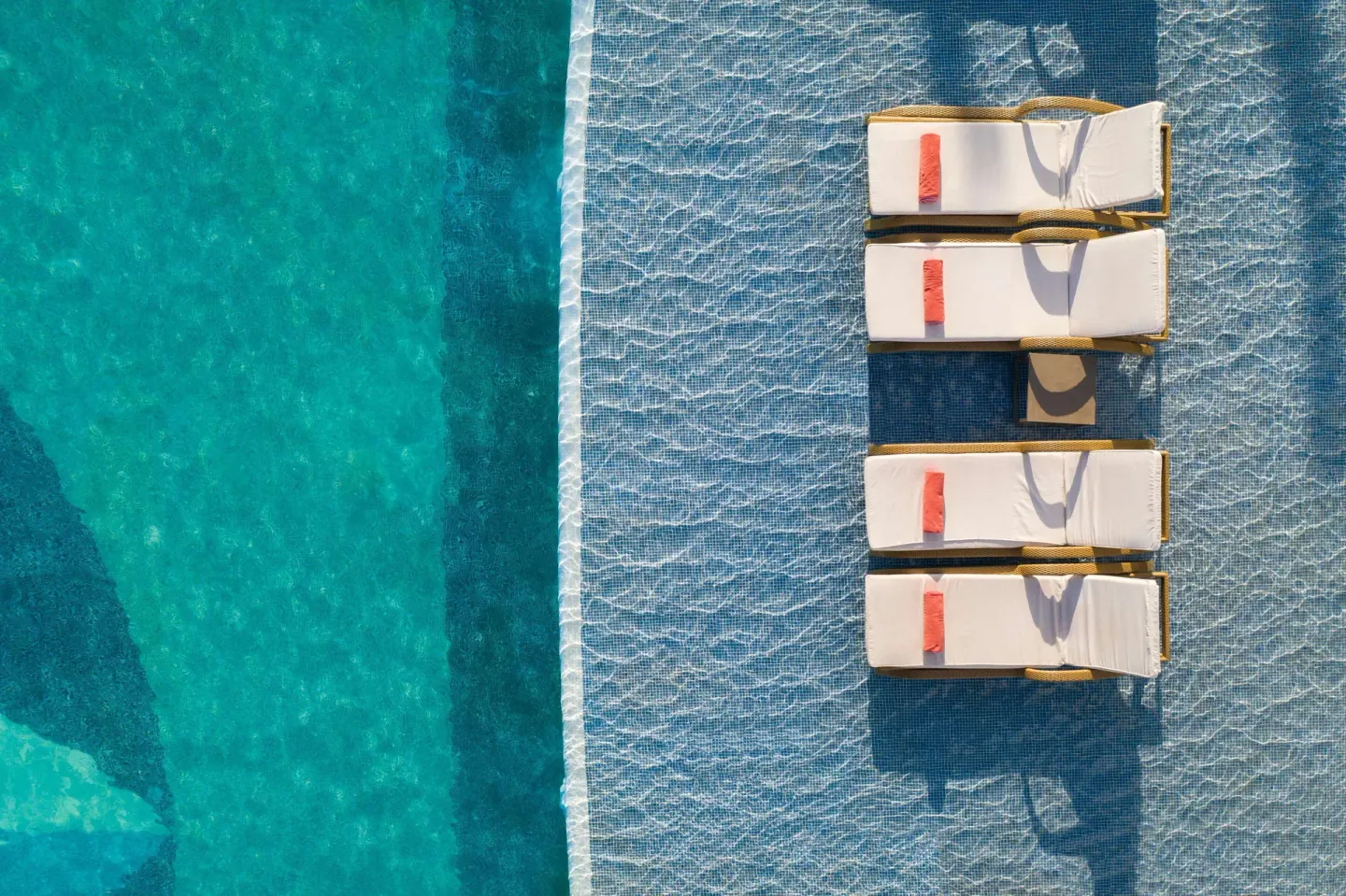Aerial view of in-pool loungers and blue water at JOIA Paraíso by Iberostar.