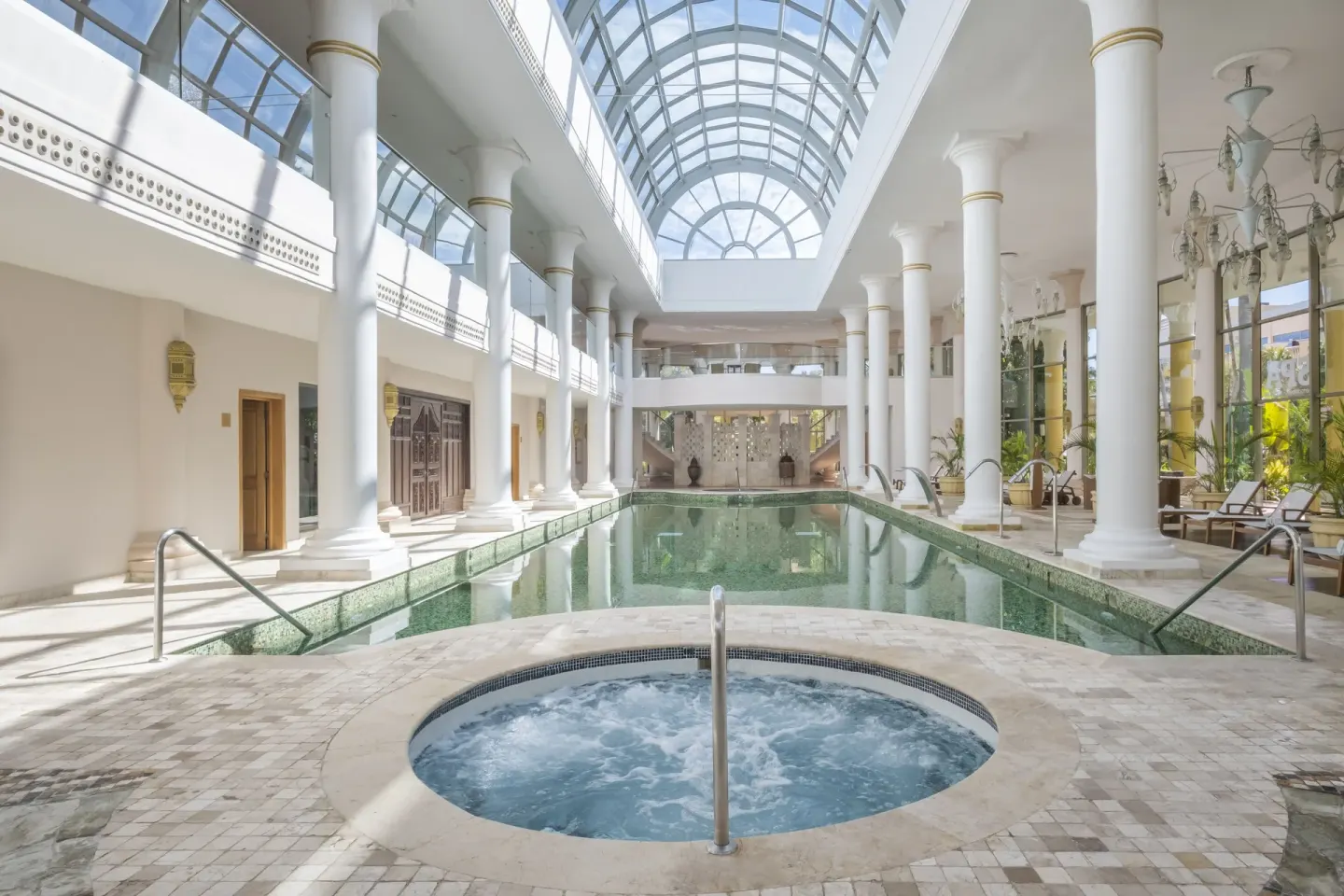 Indoor pool hall with whirlpool and glass skylight at JOIA Paraíso by Iberostar.