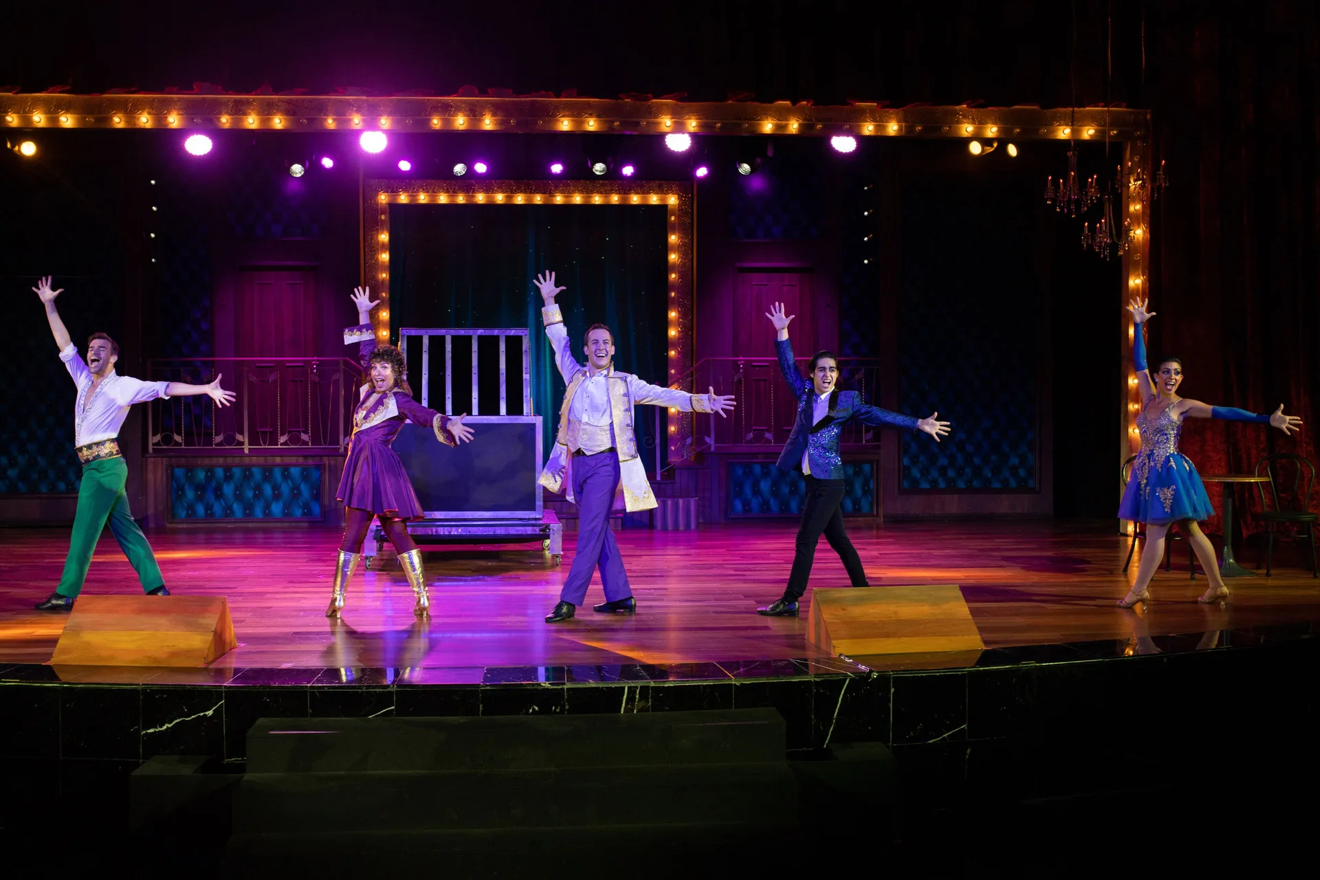 Live stage performance at JOIA Paraíso by Iberostar with dancers under colorful theater lights.