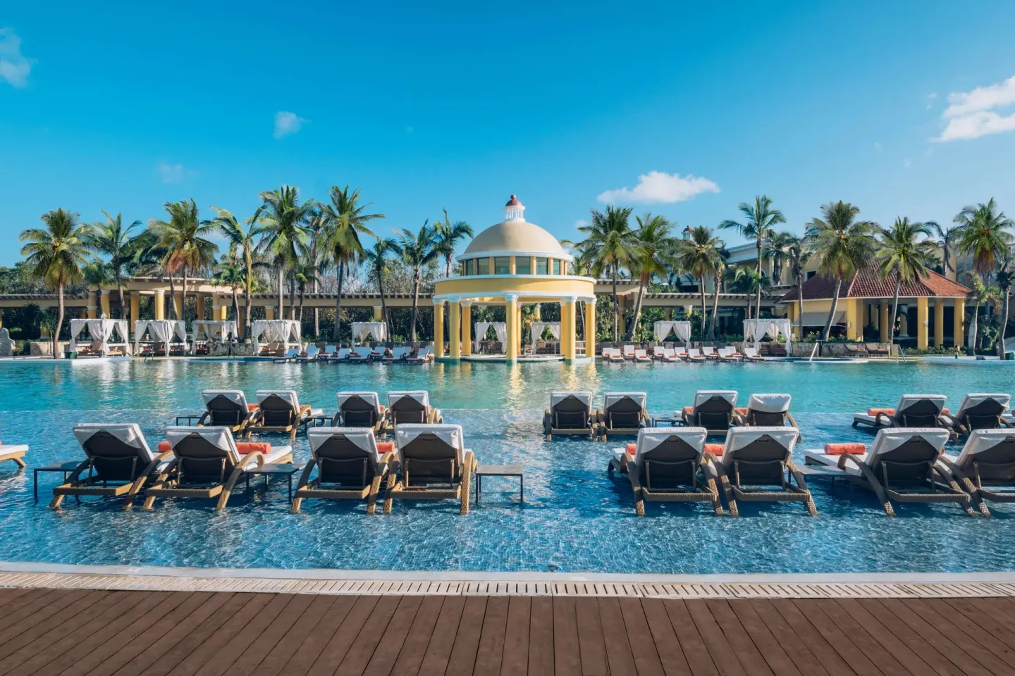 Main pool with in-water loungers and a domed pavilion at JOIA Paraíso by Iberostar.