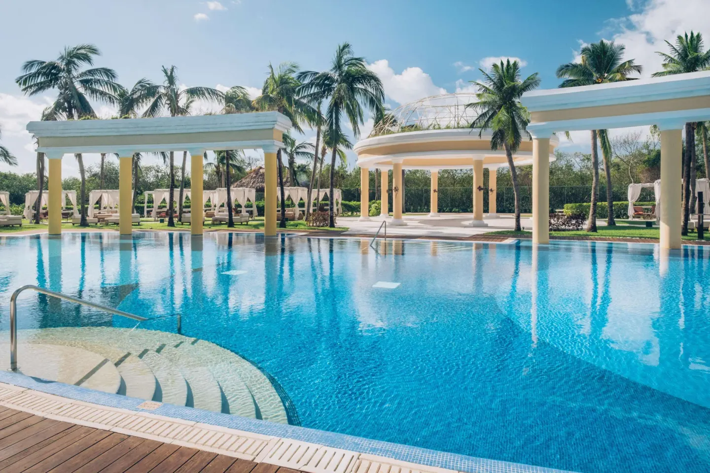 Pool steps, pavilions, and palm reflections at JOIA Paraíso by Iberostar.
