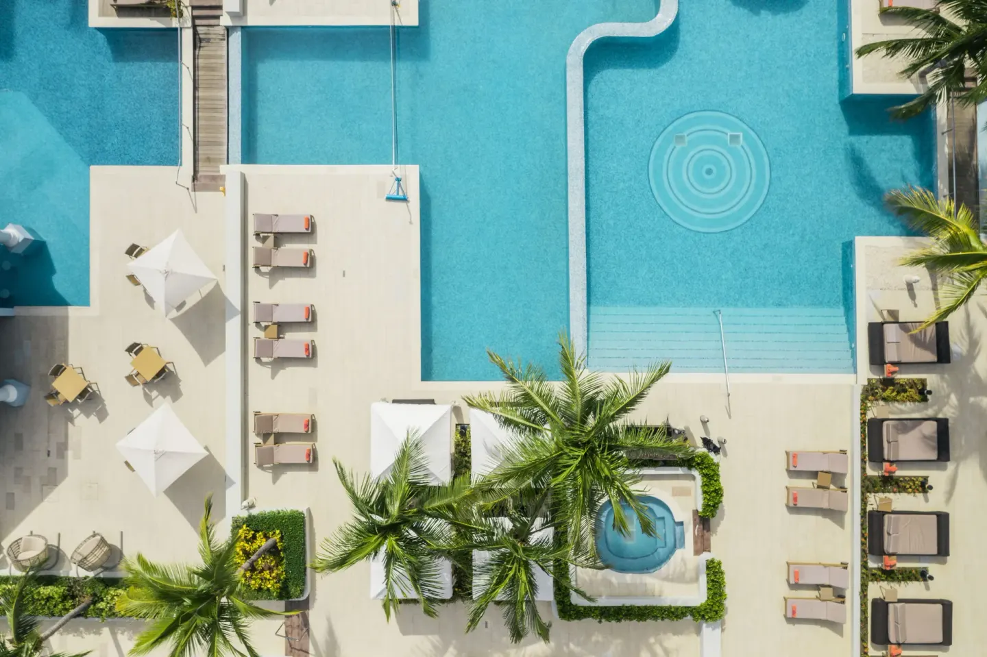 Aerial view of pool decks and loungers at JOIA Rose Hall by Iberostar.
