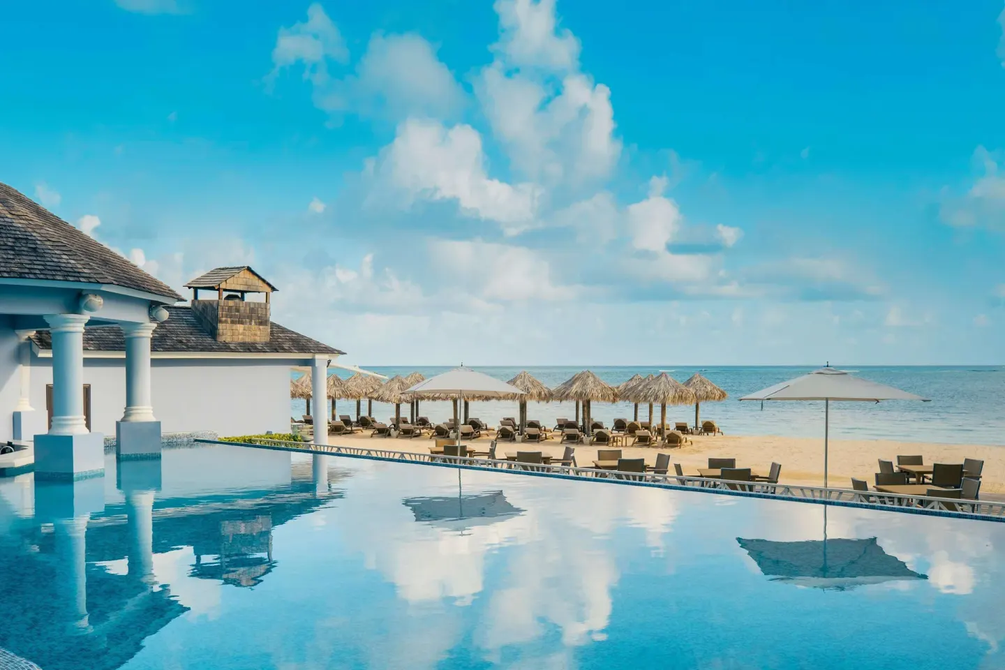 Infinity pool beside the beach at JOIA Rose Hall by Iberostar.