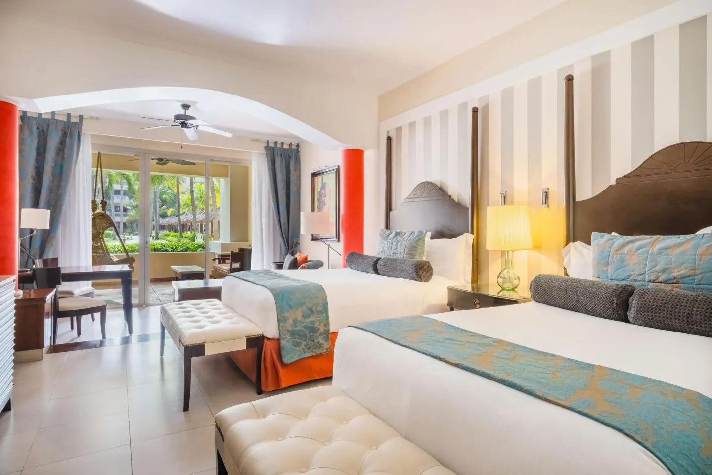 Double bed guest room with sitting area and terrace at JOIA Rose Hall by Iberostar.