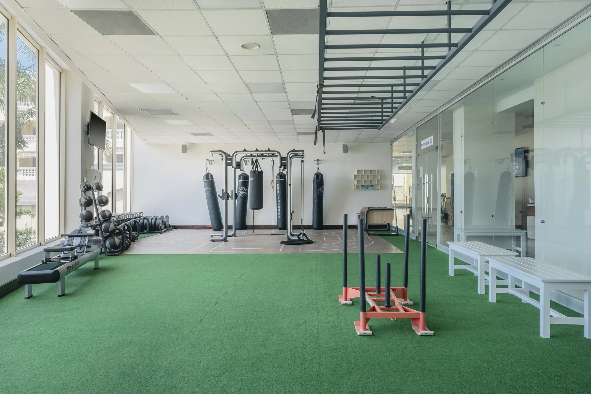 Open turf training zone with sleds, benches and boxing equipment at JOIA Rose Hall by Iberostar.