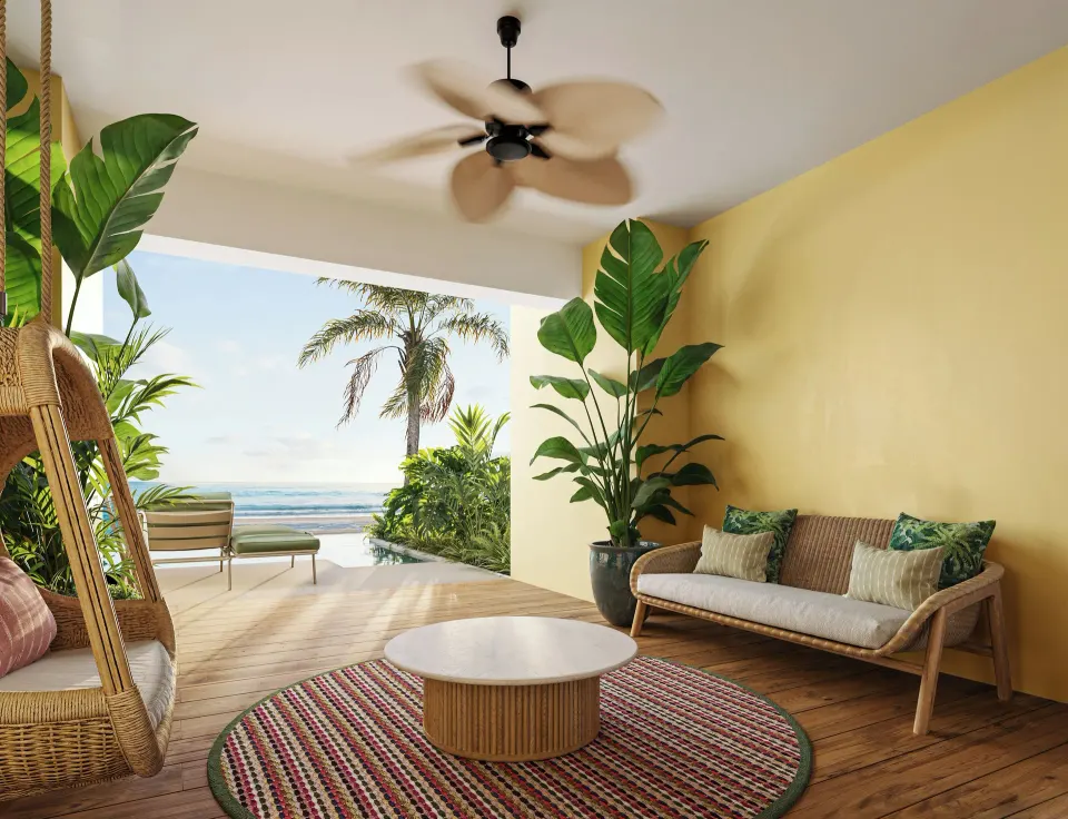 Covered oceanfront terrace seating for a swim-out suite at JOIA Rose Hall by Iberostar.