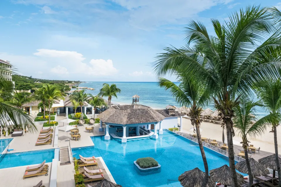 Ocean-view pool and beach scene from a suite at JOIA Rose Hall by Iberostar.