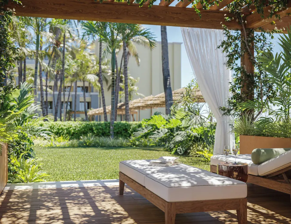 Private garden deck with loungers for a Pool View Suite at JOIA Rose Hall by Iberostar.
