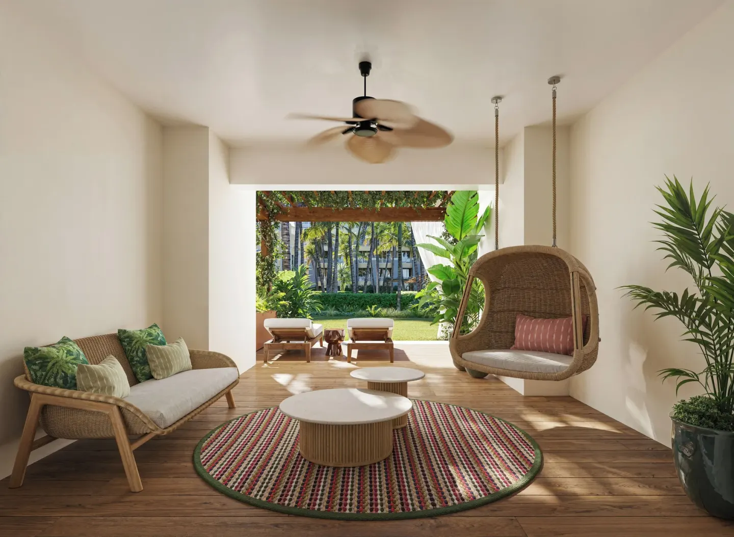 Private garden terrace with wicker seating for a Pool View Suite at JOIA Rose Hall by Iberostar.
