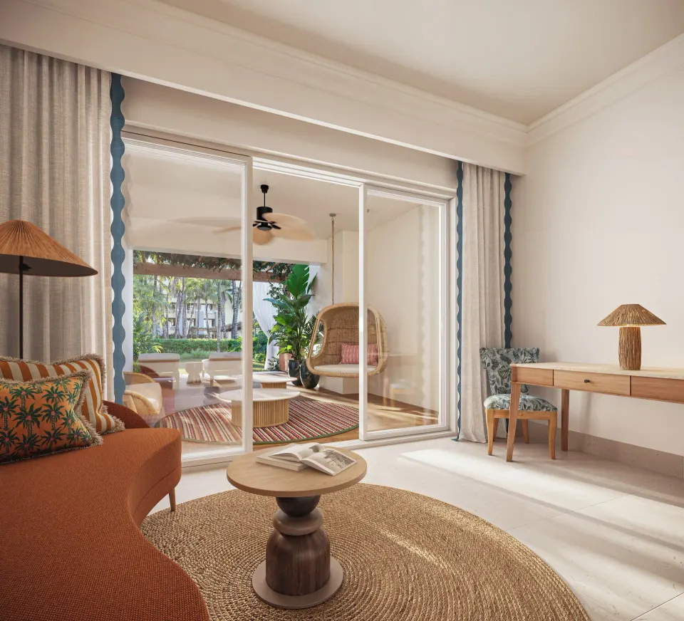 Pool View Suite sitting area with sliding doors to the terrace at JOIA Rose Hall by Iberostar.