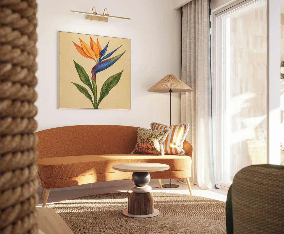 Suite lounge nook with orange sofa at JOIA Rose Hall by Iberostar.