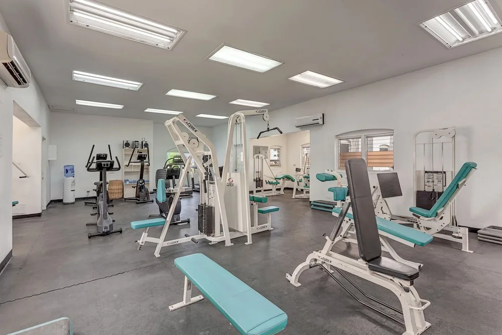 Fitness room with weight machines and cardio equipment at Jolly Beach Antigua.