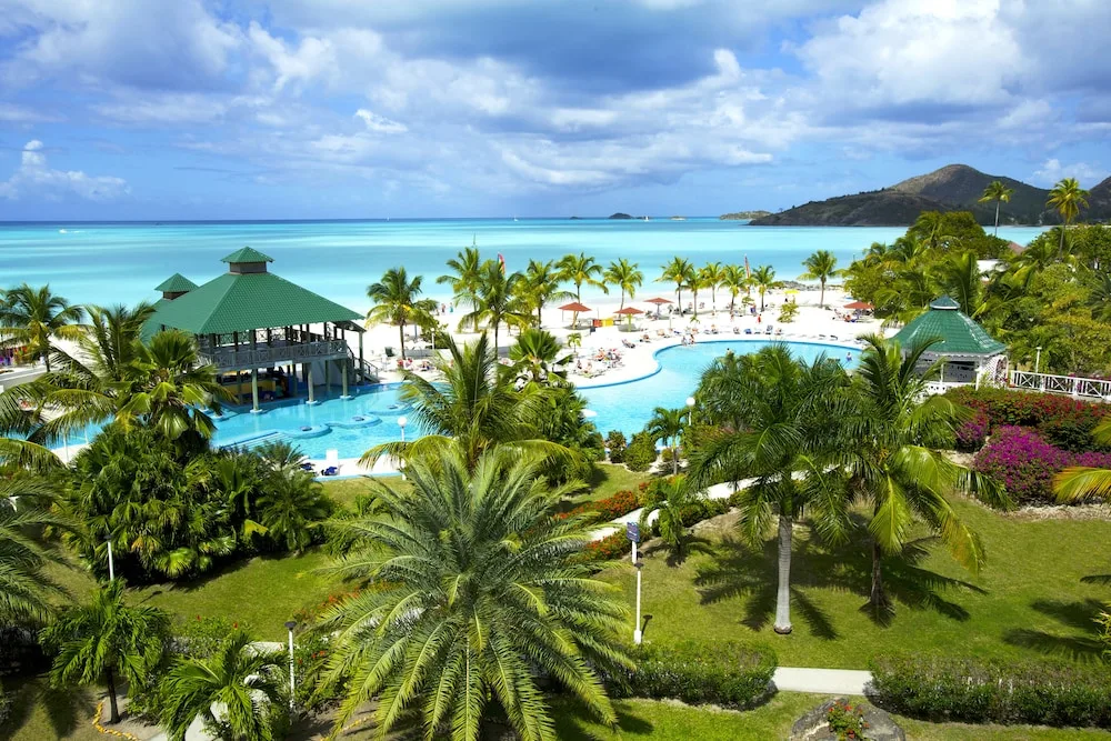 Aerial view of the pool, palms, beach and turquoise sea at Jolly Beach Antigua.