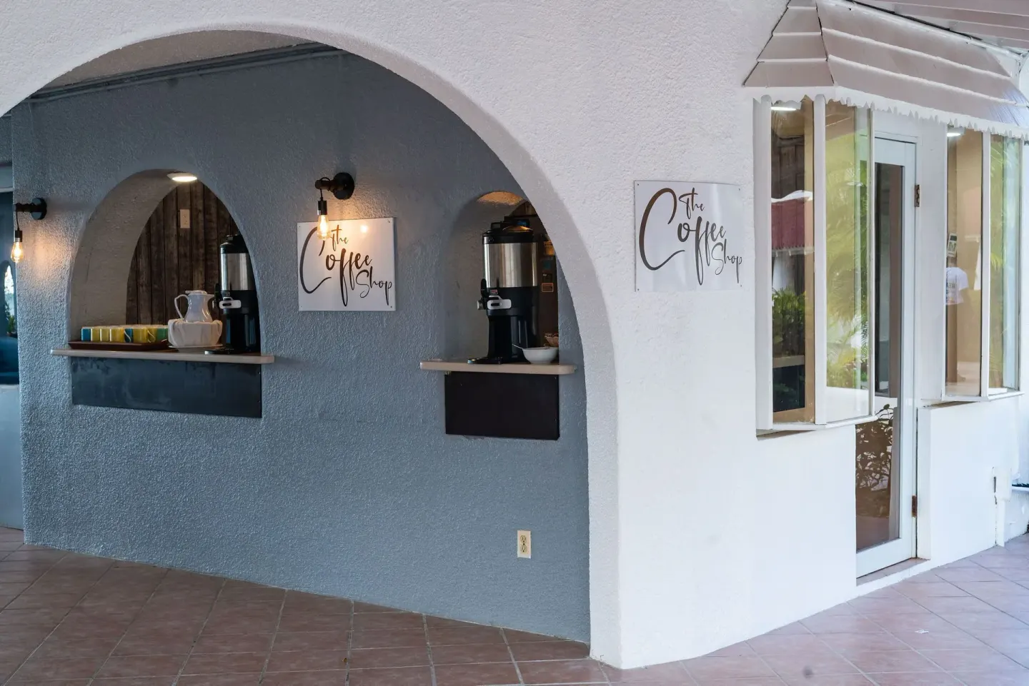 The Coffee Shop service windows and signage at Jolly Beach Antigua.