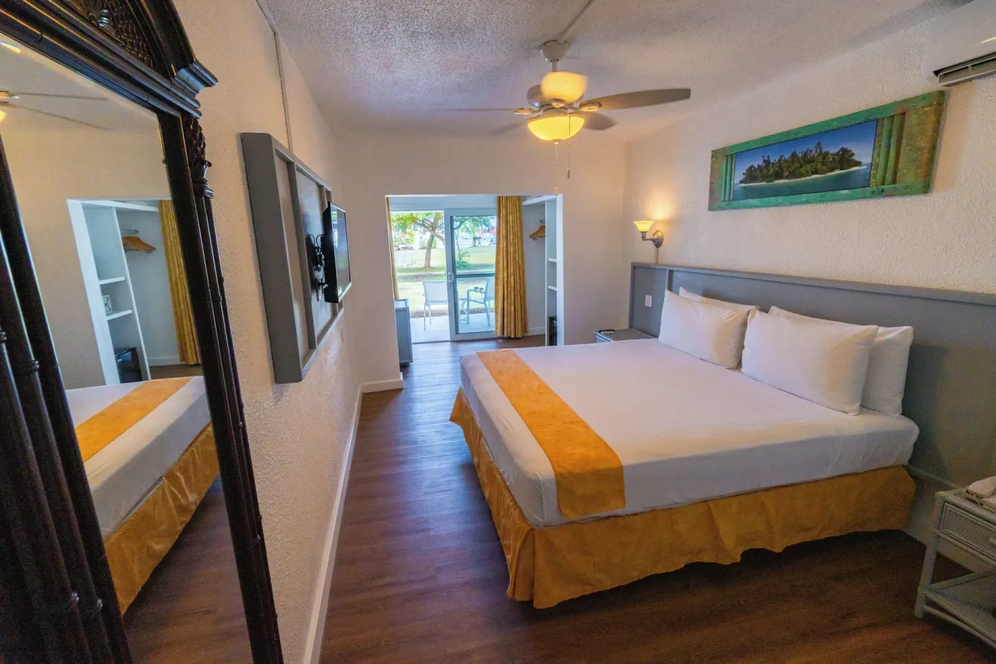 Superior Room king bed with patio doors at Jolly Beach Antigua.
