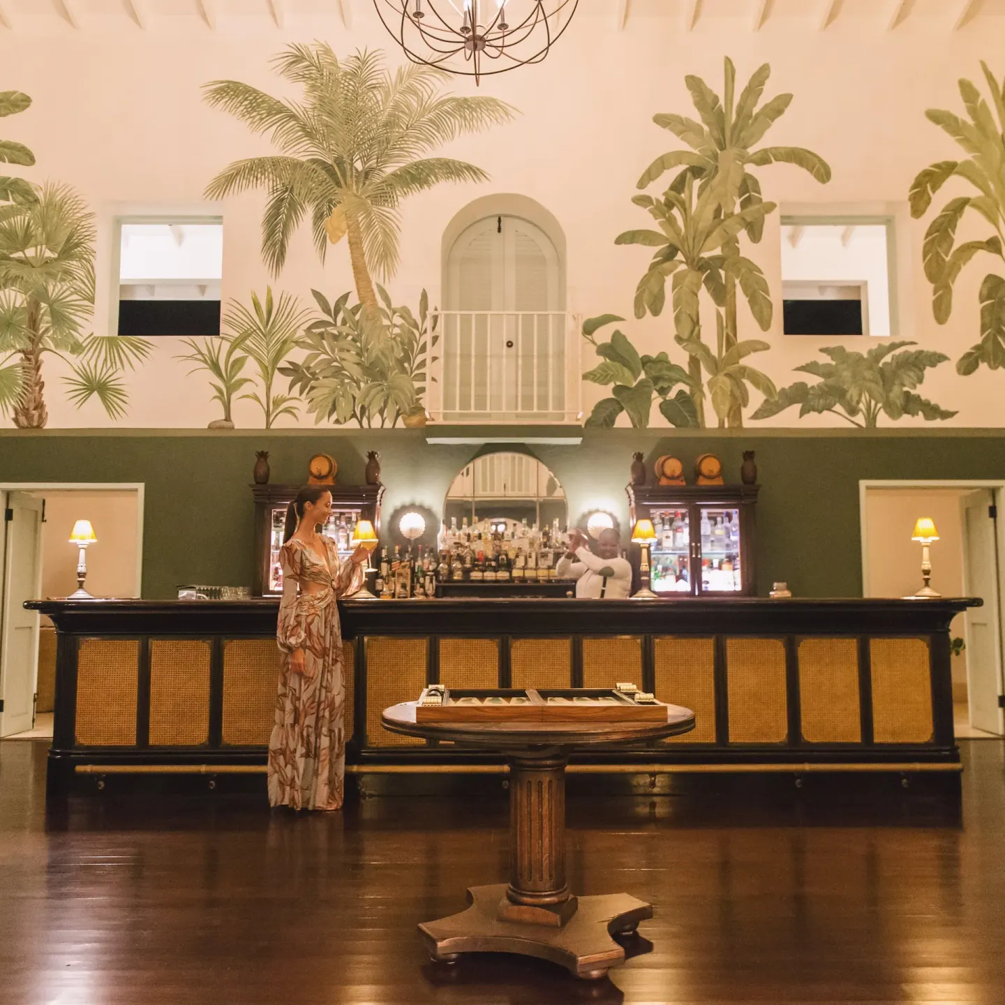 Classic cocktail bar with tropical mural at Jumby Bay Island.