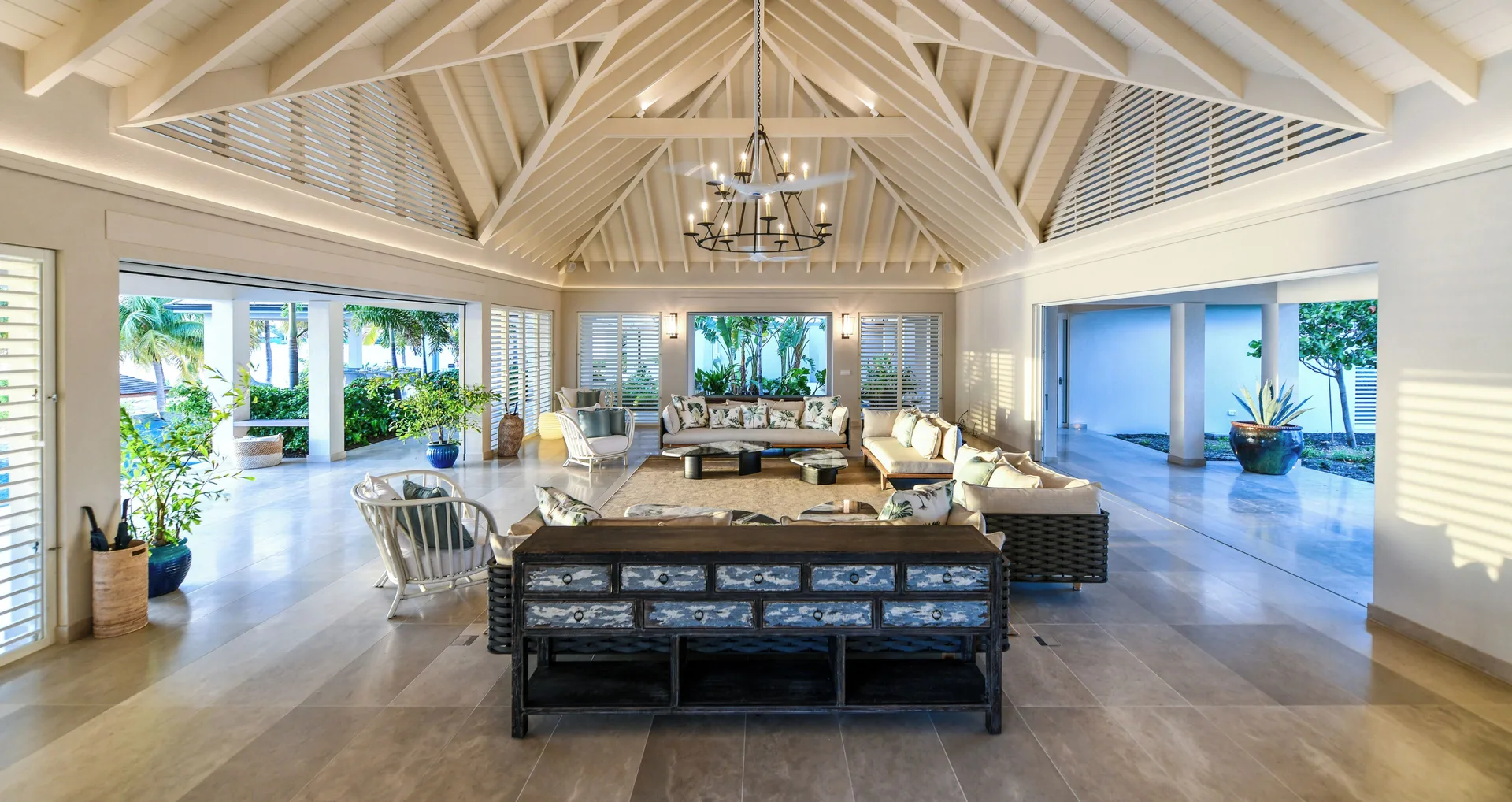 Delphis living room with vaulted ceiling and garden openings at Jumby Bay Island.