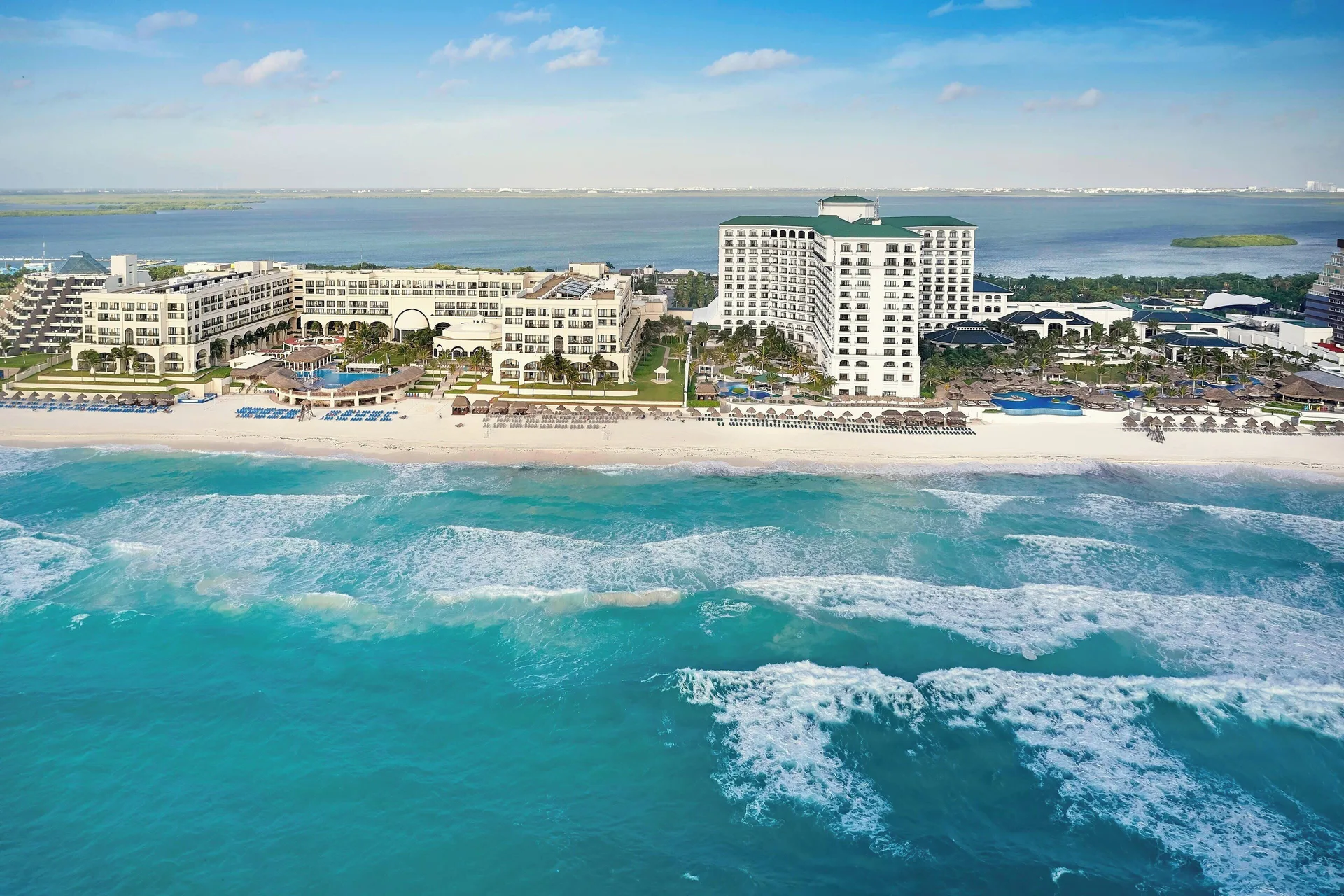 Aerial view of the beachfront resort and turquoise surf at JW Marriott Cancun Resort & Spa.