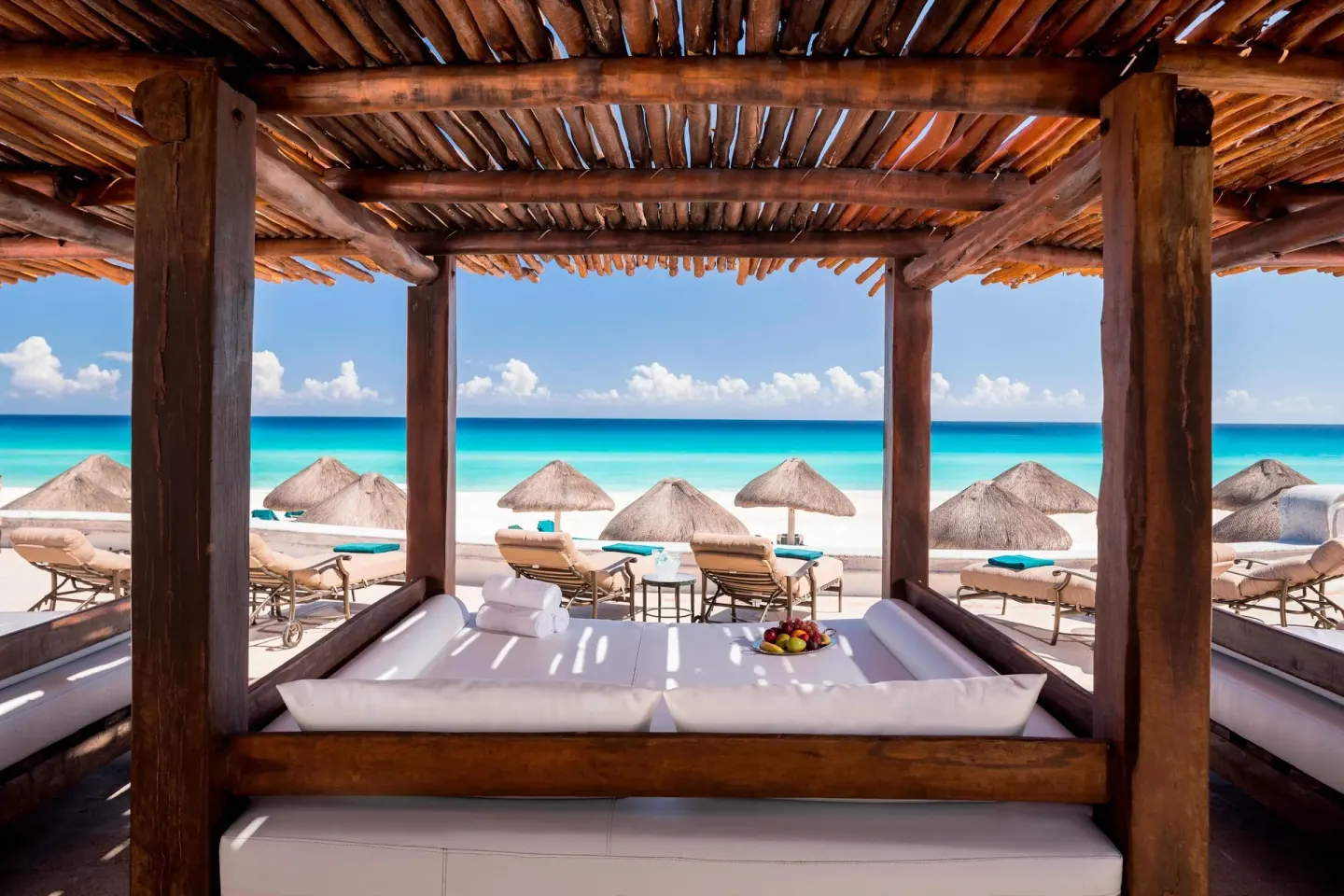 Shaded beach cabana with lounge bed at JW Marriott Cancun Resort & Spa.