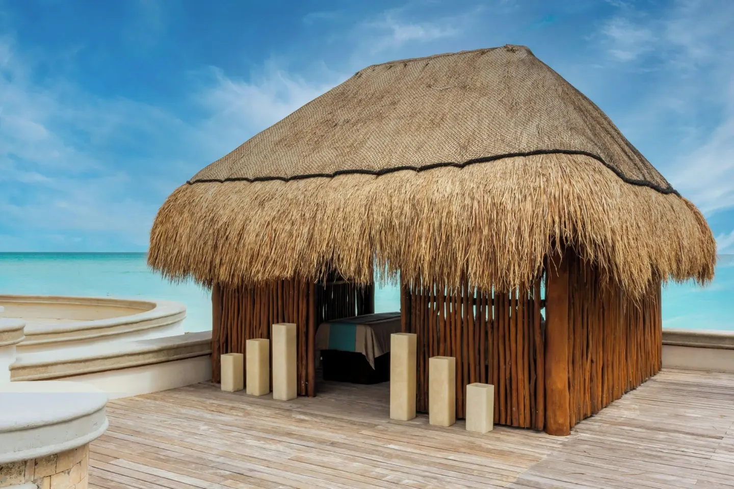 Thatched spa hut on a wooden deck at JW Marriott Cancun Resort & Spa.