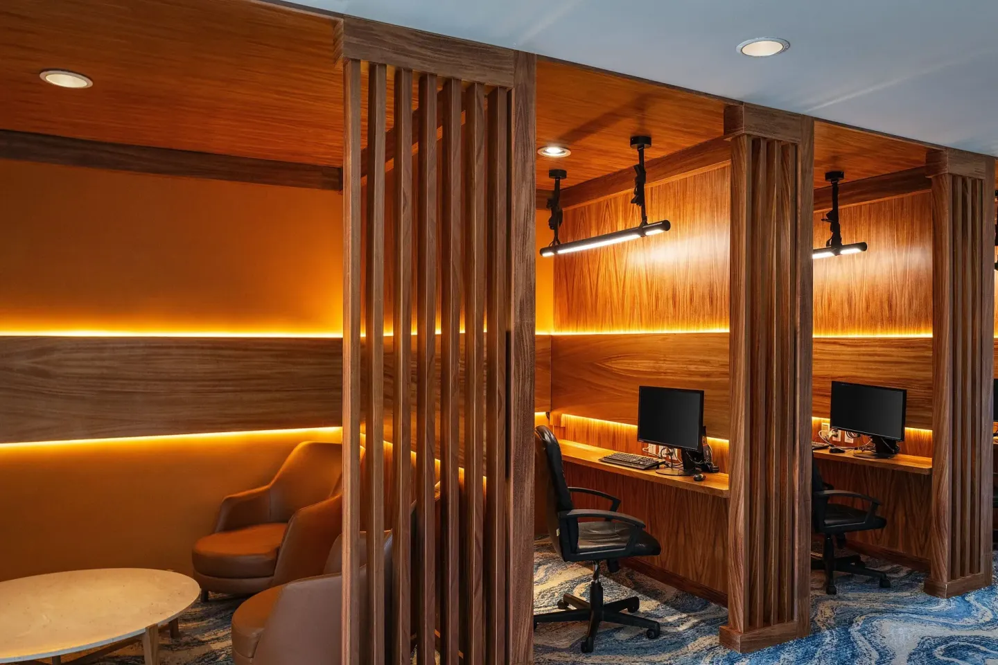Wood-paneled business alcoves with desks and computers at JW Marriott Cancun Resort & Spa.