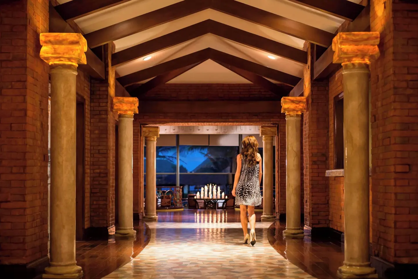 Columned resort corridor with warm lighting at JW Marriott Cancun Resort & Spa.
