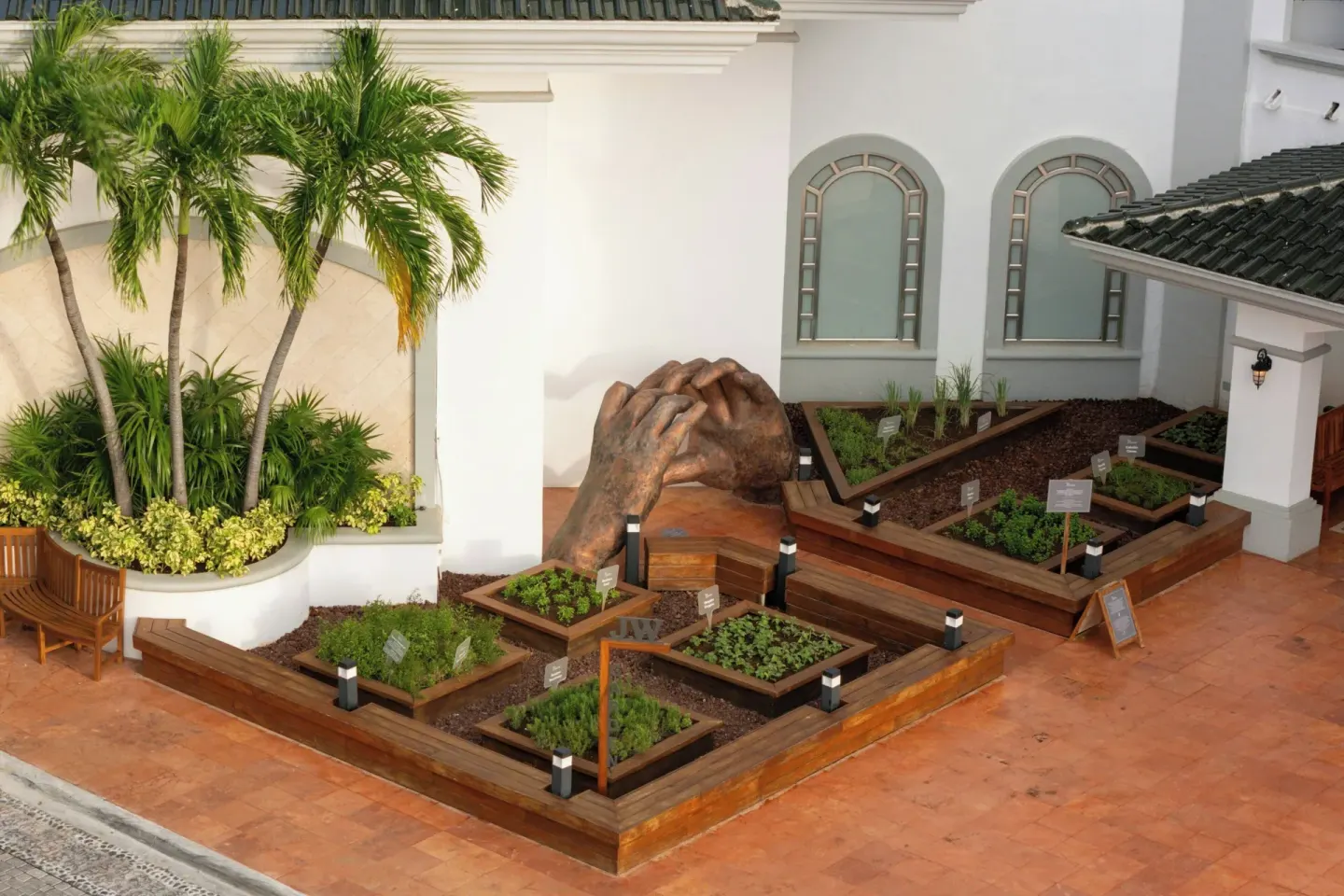 Courtyard herb garden with palms at JW Marriott Cancun Resort & Spa.