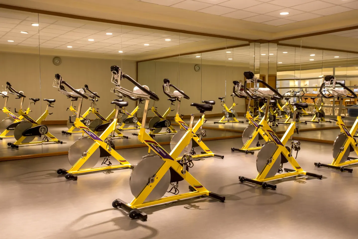 Mirrored spin studio with yellow stationary bikes at JW Marriott Cancun Resort & Spa.