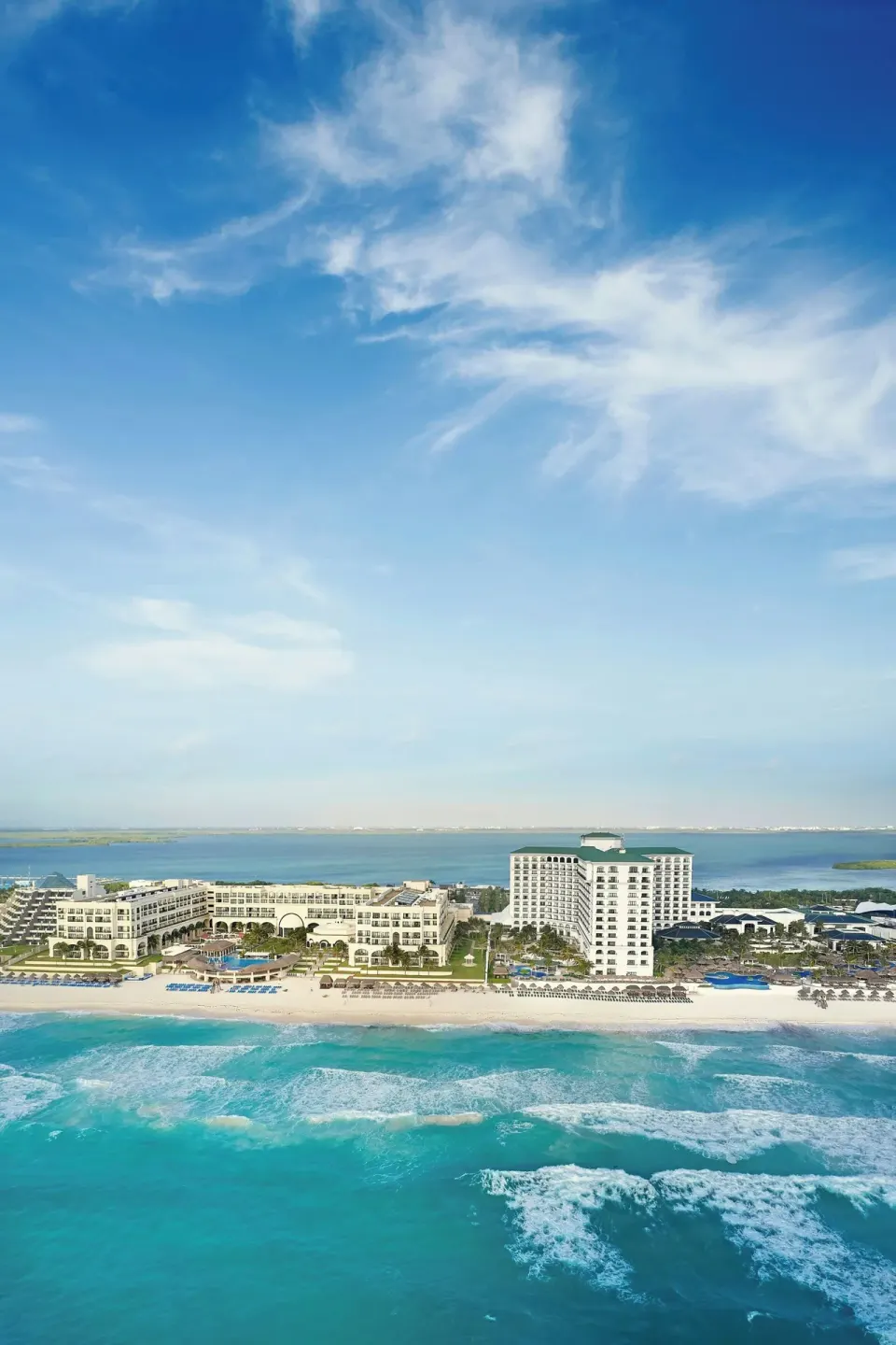Vertical aerial view of the resort, beach, ocean and lagoon at JW Marriott Cancun Resort & Spa.