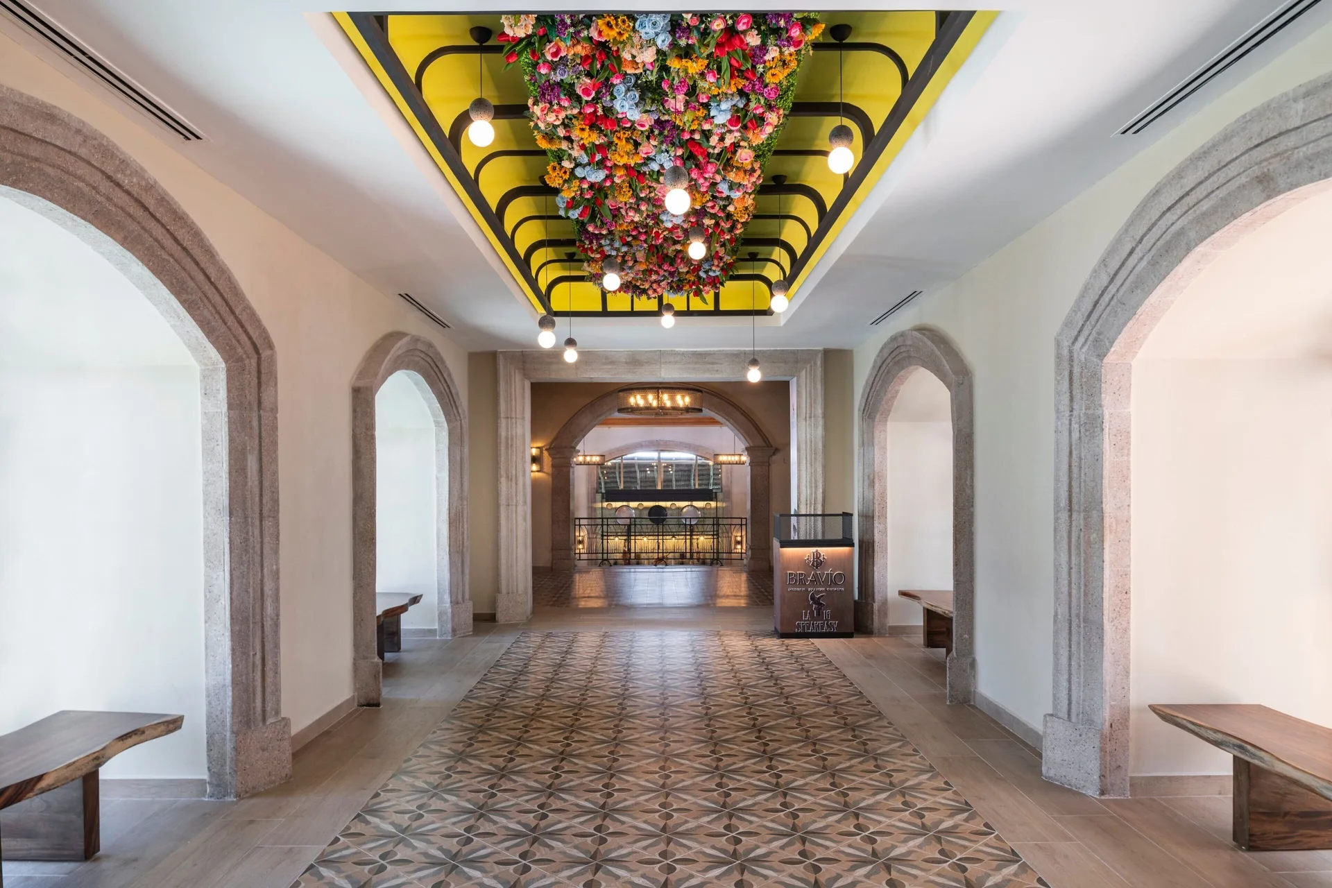 Bravio corridor with floral ceiling at JW Marriott Cancun Resort & Spa.