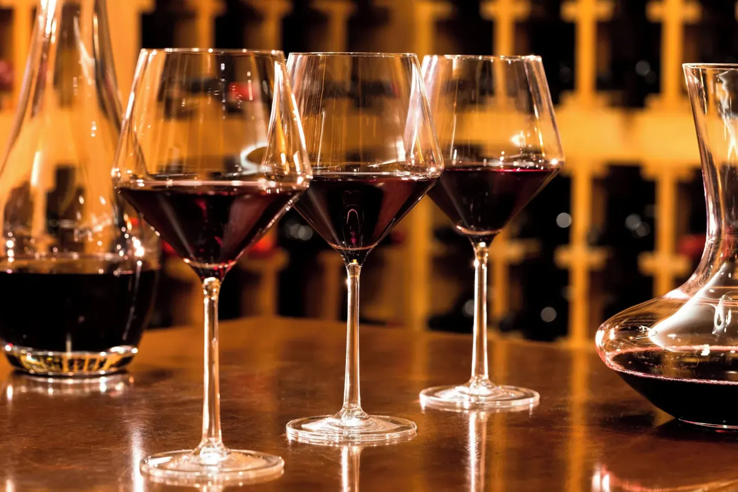 Red wine glasses and decanters on a polished table at JW Marriott Cancun Resort & Spa.