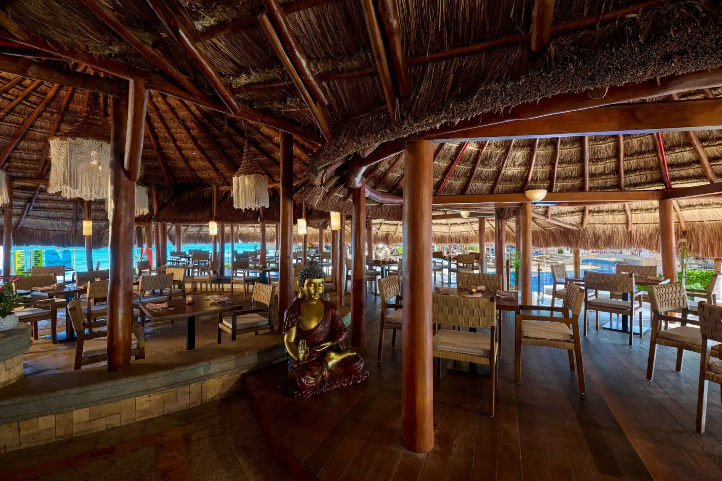 Open-air thatched restaurant with pool views at JW Marriott Cancun Resort & Spa.