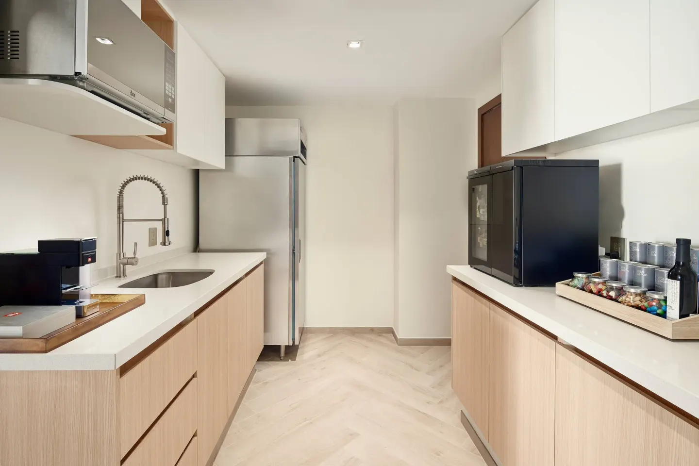 Club 91 kitchenette with sink, refrigerator and refreshments at JW Marriott Cancun Resort & Spa.