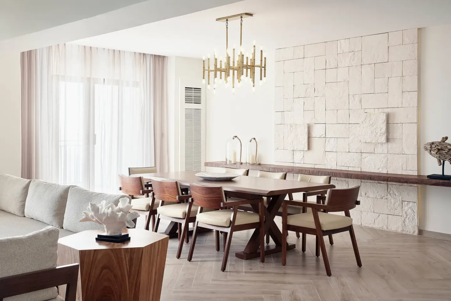 Presidential Suite dining area with wood table and stone wall at JW Marriott Cancun Resort & Spa.