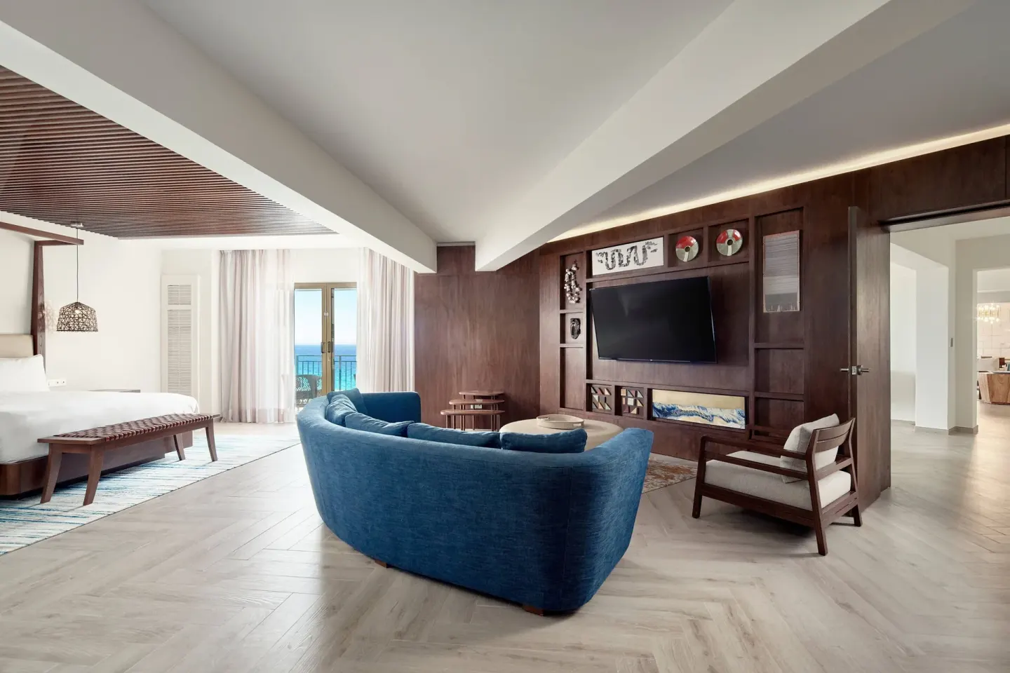 Presidential Suite bedroom lounge with king bed and blue sofa at JW Marriott Cancun Resort & Spa.