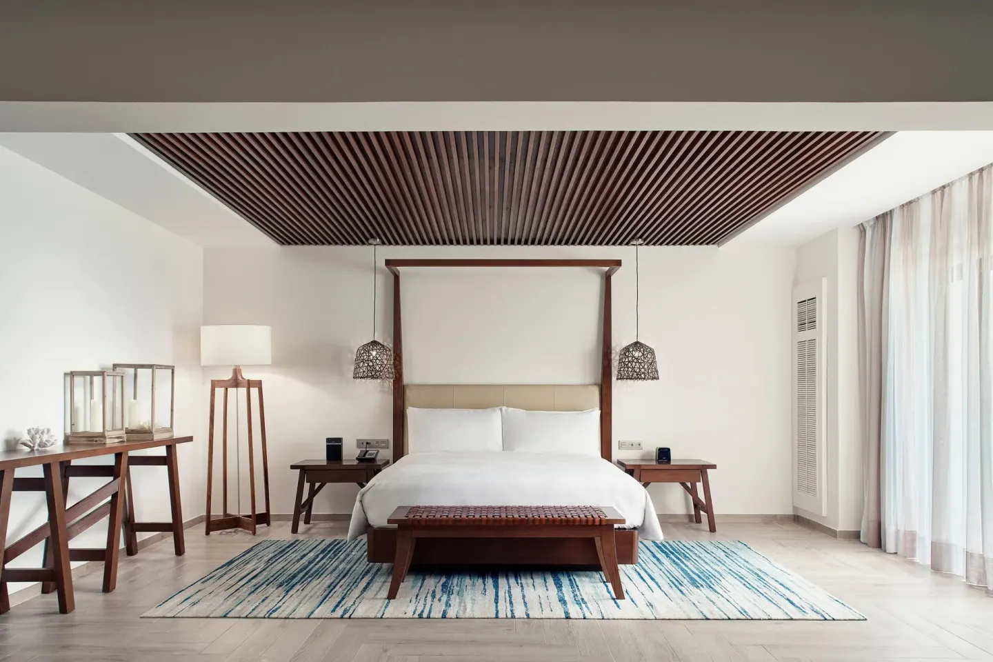 Presidential Suite bedroom with king bed and wood-slat ceiling at JW Marriott Cancun Resort & Spa.
