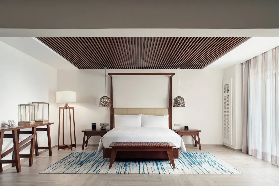 Presidential Suite bedroom with king bed and wood-slat ceiling at JW Marriott Cancun Resort & Spa.