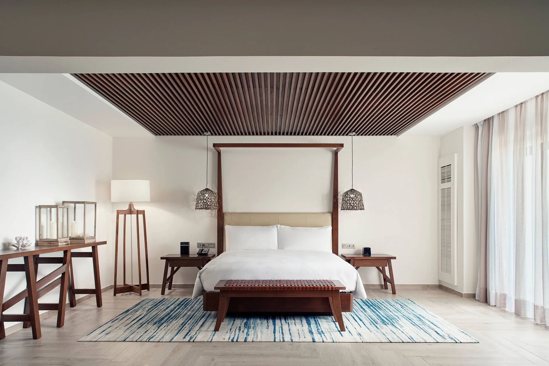 Presidential Suite bedroom with king bed and wood-slat ceiling at JW Marriott Cancun Resort & Spa.