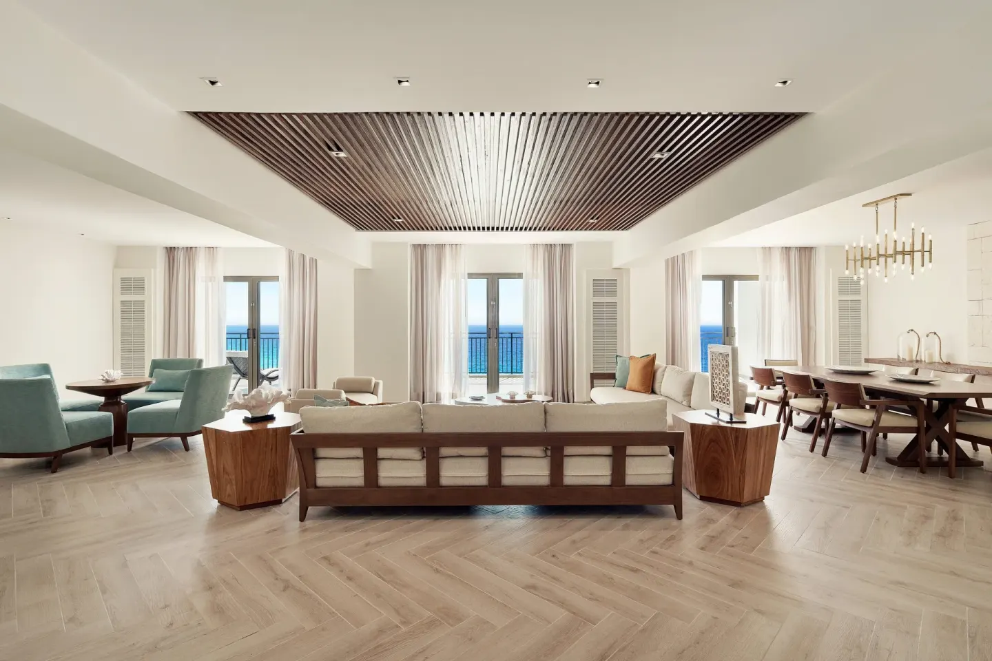 Presidential Suite living and dining room with ocean-facing doors at JW Marriott Cancun Resort & Spa.