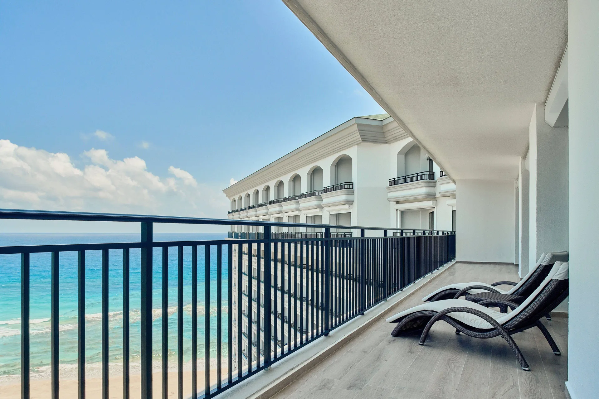 Presidential Suite balcony with lounge chairs and ocean view at JW Marriott Cancun Resort & Spa.
