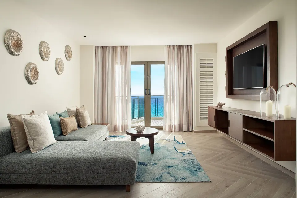 Presidential Suite sitting area with sectional sofa and balcony doors at JW Marriott Cancun Resort & Spa.