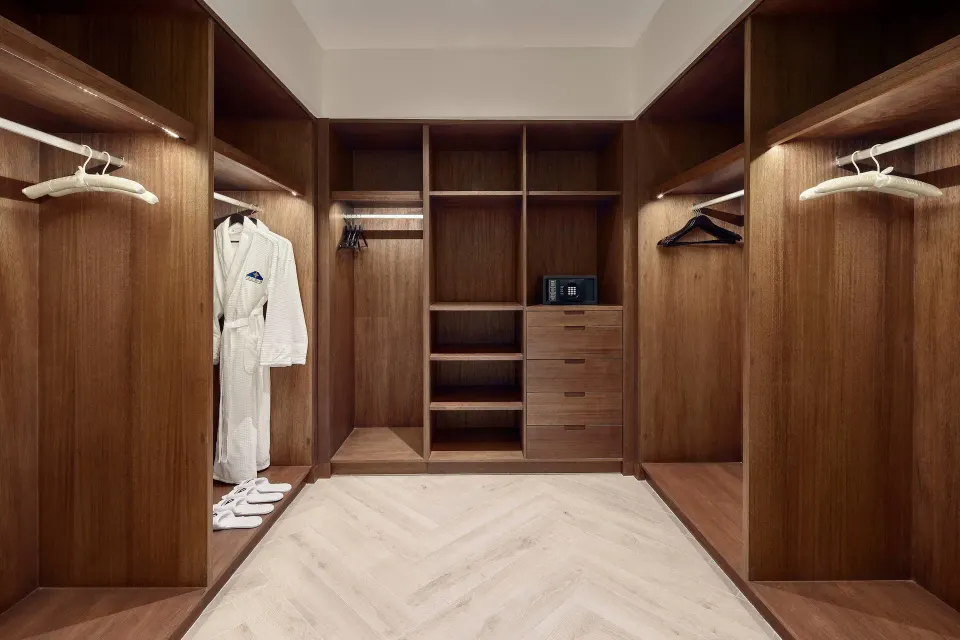 Walk-in closet with wood shelving in the Presidential Suite at JW Marriott Cancun Resort & Spa.