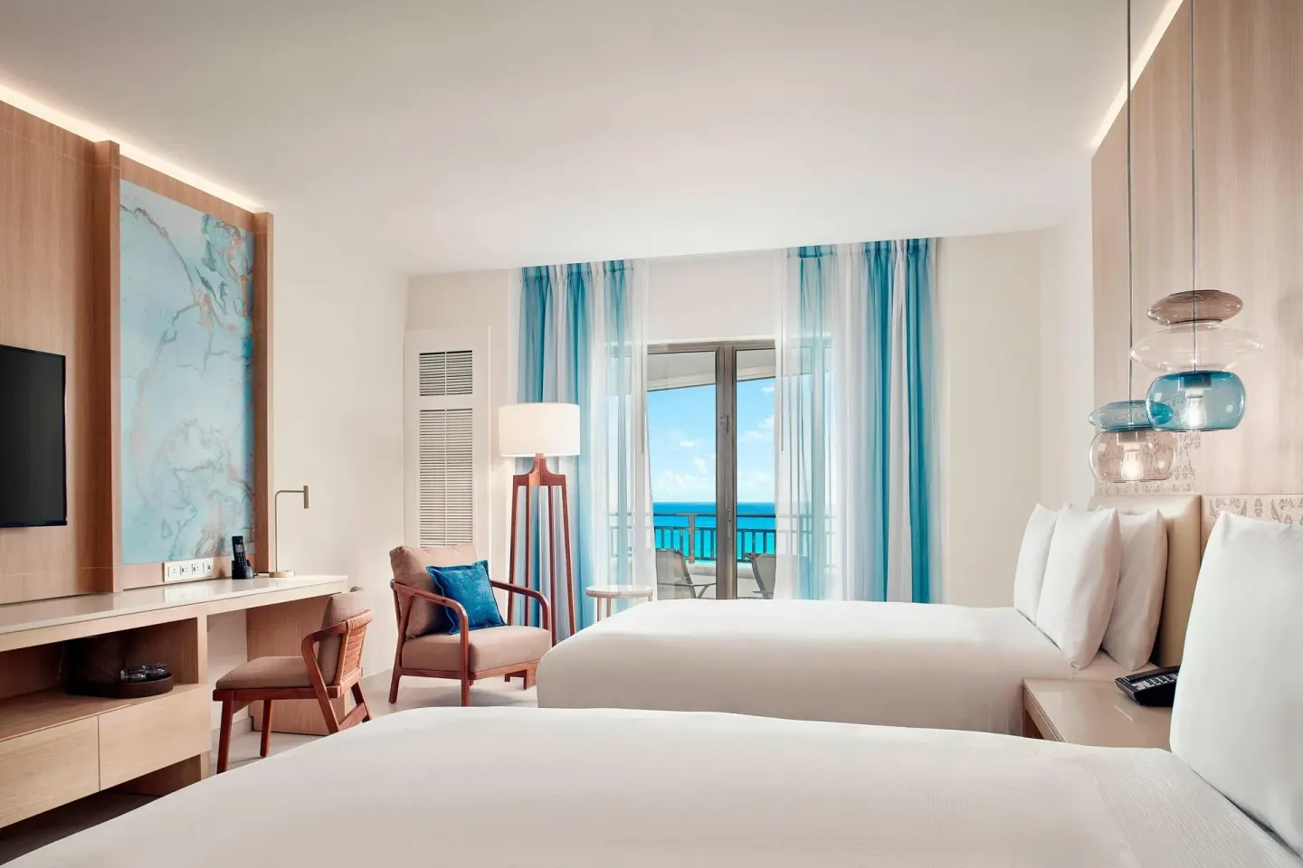 Two-bed guest room with balcony ocean view at JW Marriott Cancun Resort & Spa.