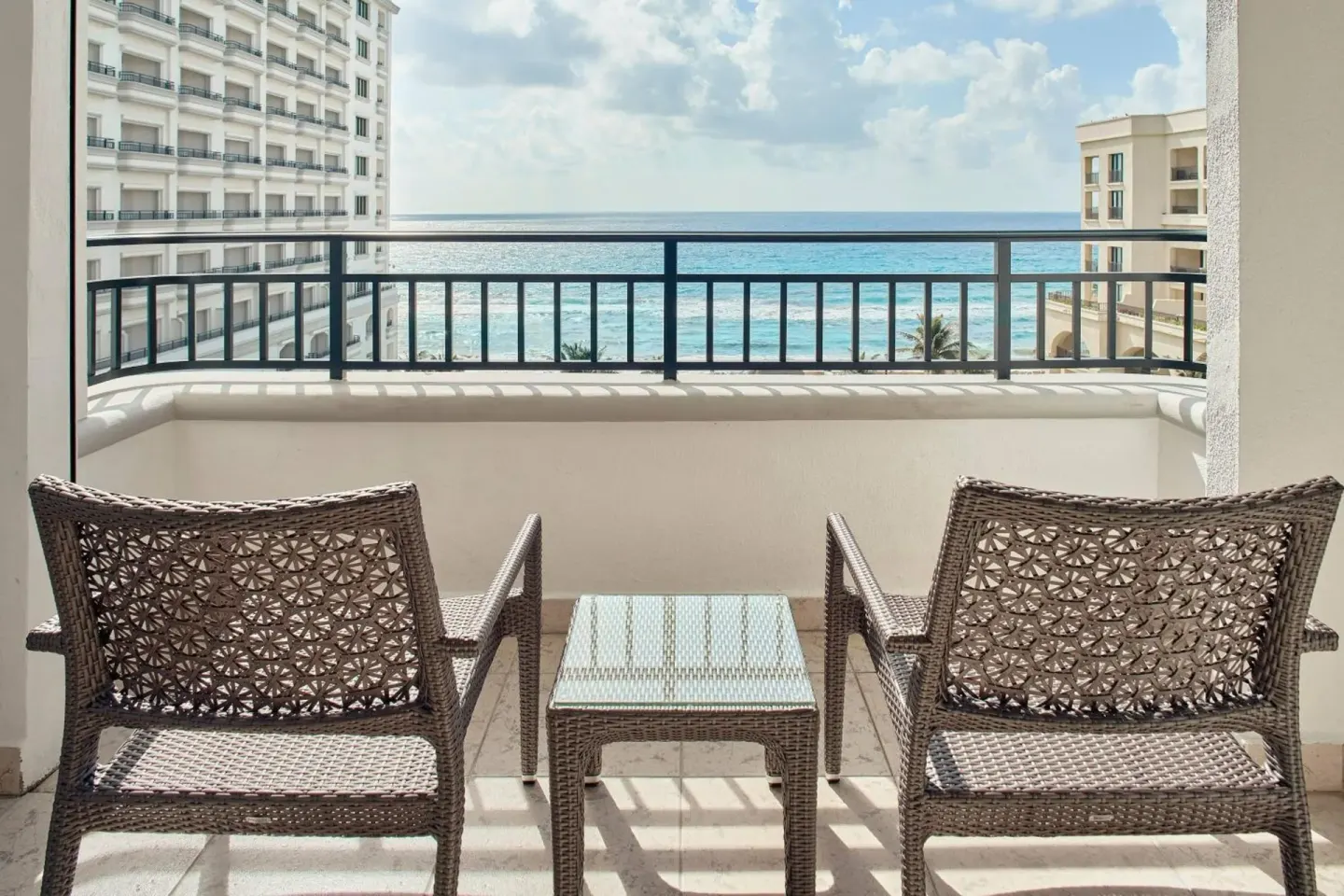 Deluxe Room Ocean View balcony seating at JW Marriott Cancun Resort & Spa.
