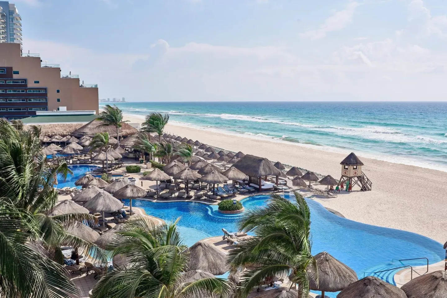 Daytime beach and pool view from JW Marriott Cancun Resort & Spa.