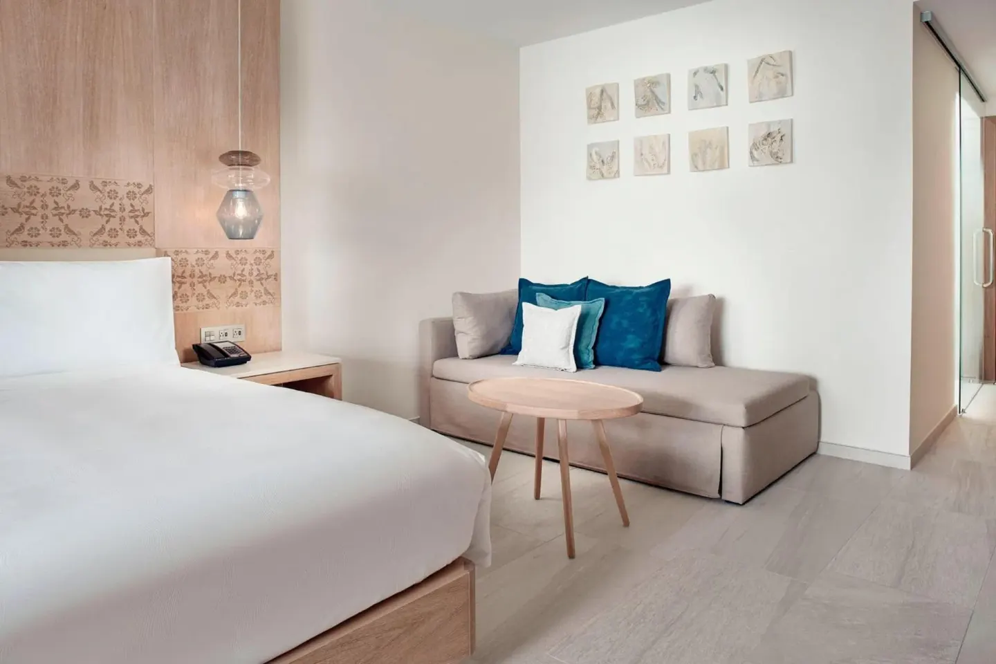 Deluxe Room Ocean View king bed and sofa seating at JW Marriott Cancun Resort & Spa.
