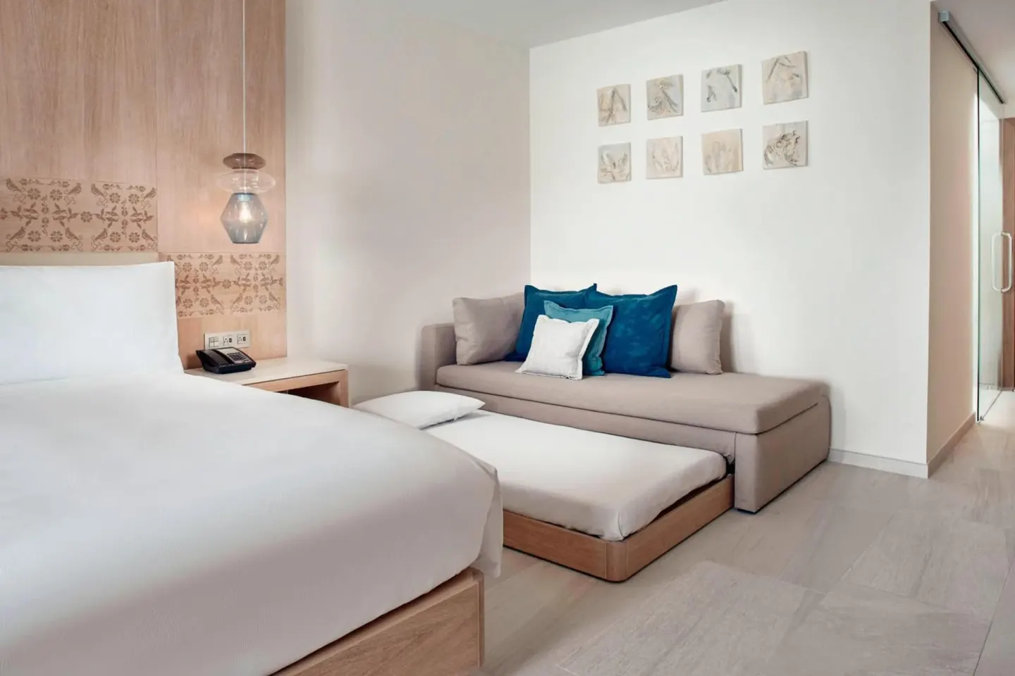 Deluxe Room Ocean View king bed and sofa seating at JW Marriott Cancun Resort & Spa.